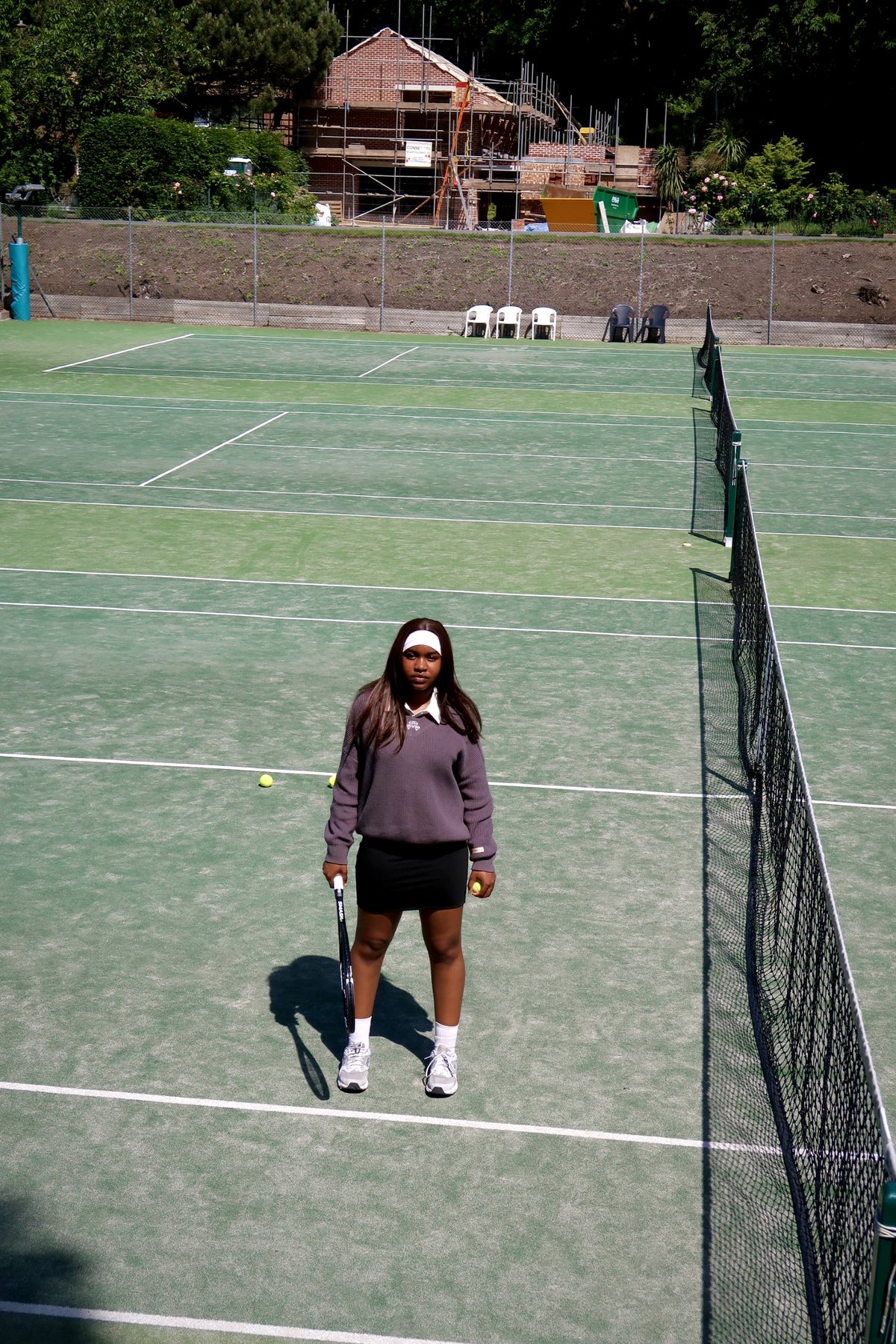 Member standing on court with racquet