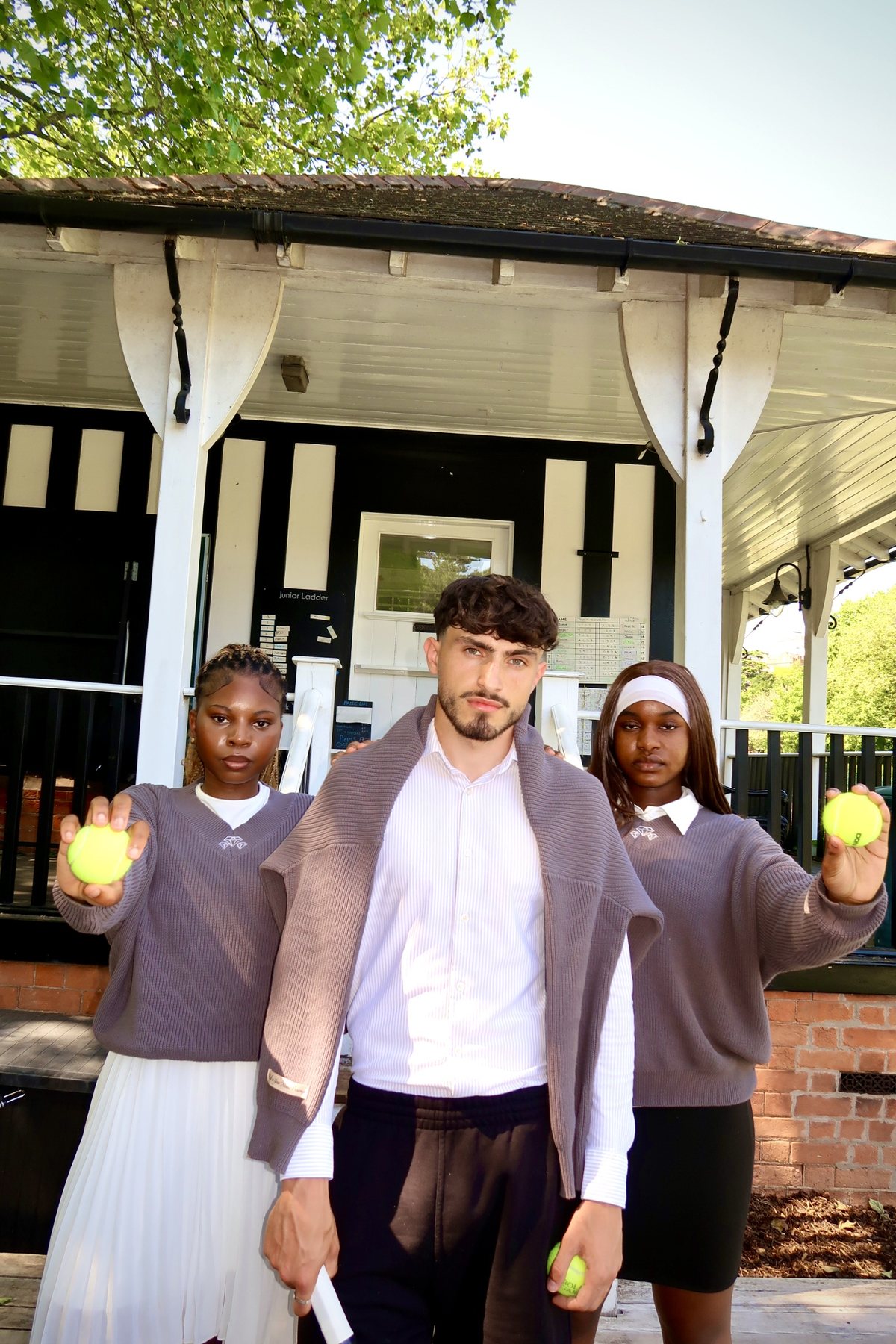 Three members in front of the pavilion